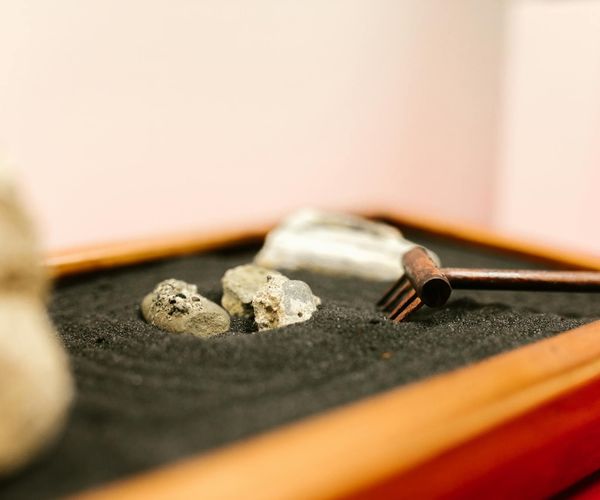 A serene zen garden with raked sand and smooth stones.